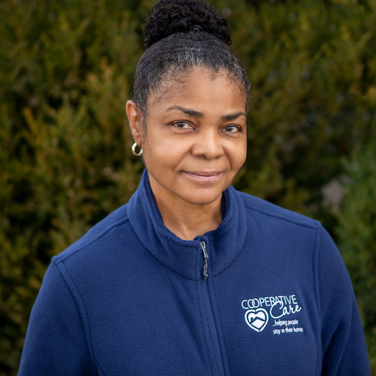 Cooperative Care staff member wearing a blue zip up jacket with logo on the front
