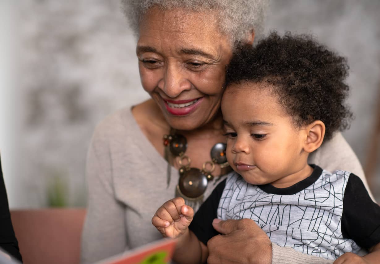 Grandmother holding her grandchild and smiling